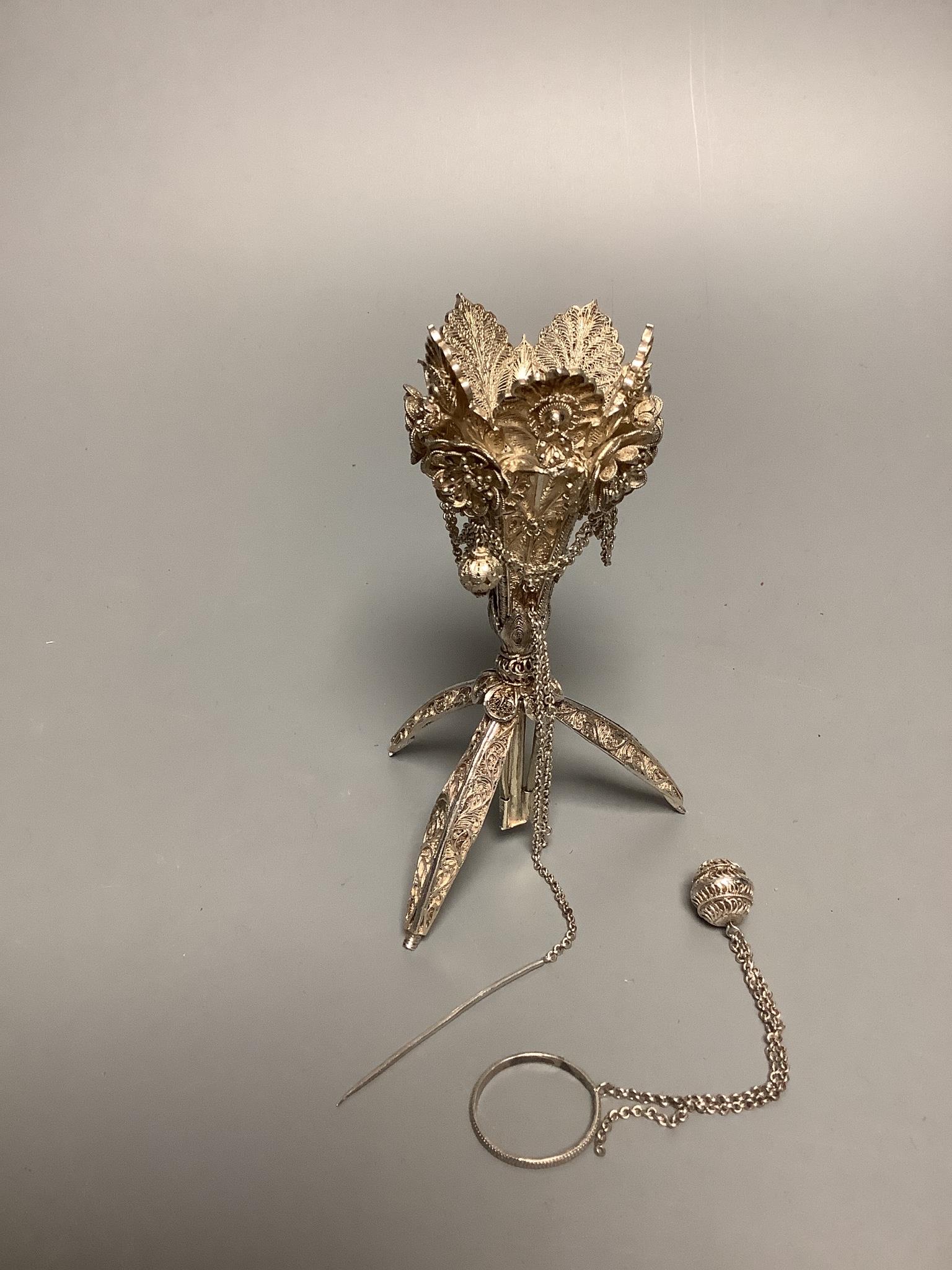 A late 19th century white metal filigree posy holder, 14.1cm. The ball at the base unscrewing to reveal three spring-loaded legs